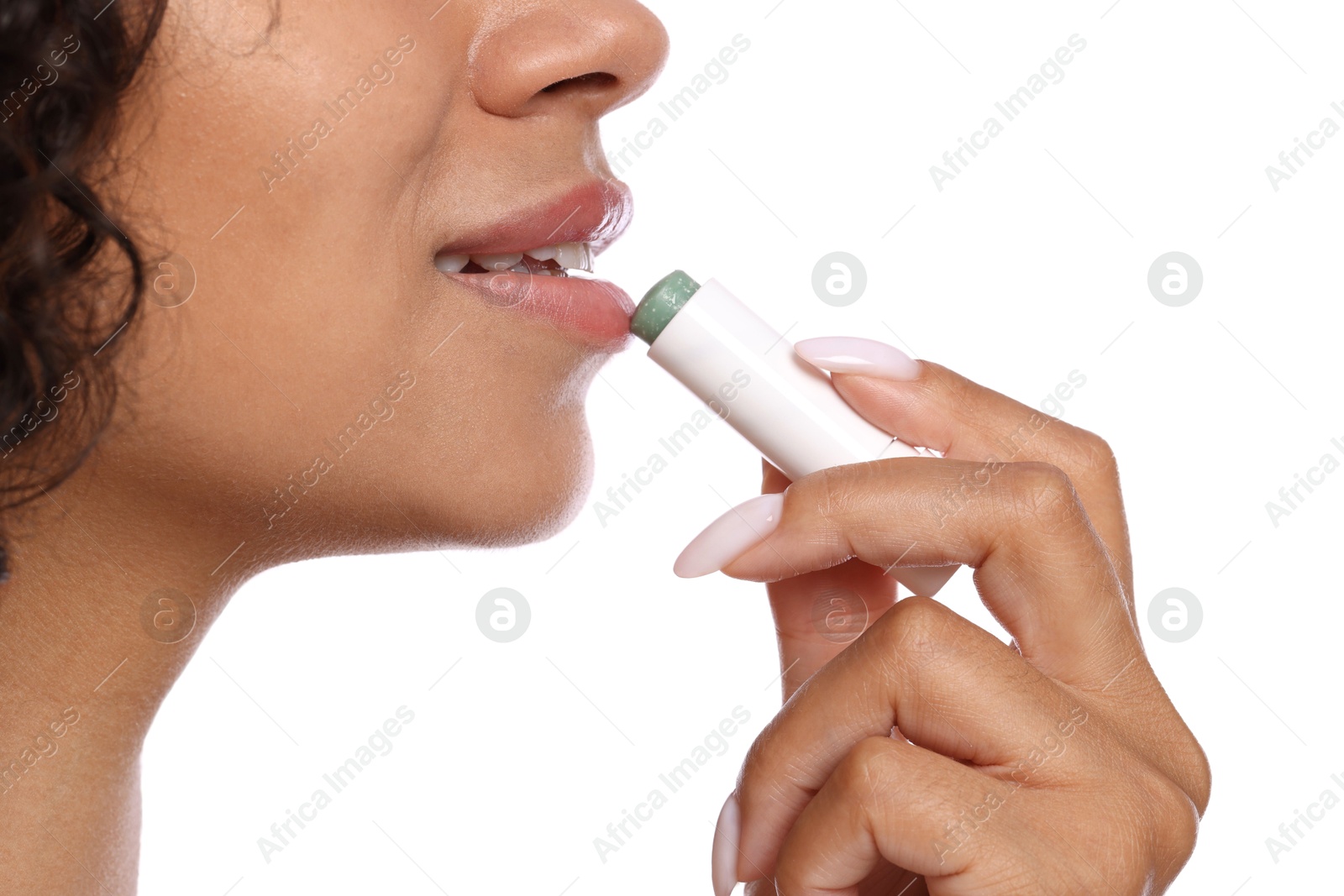 Smiling woman applying lip balm onto her lips on white background, closeup Photo of Smiling woman applying lip balm onto her lips on white background, closeup
