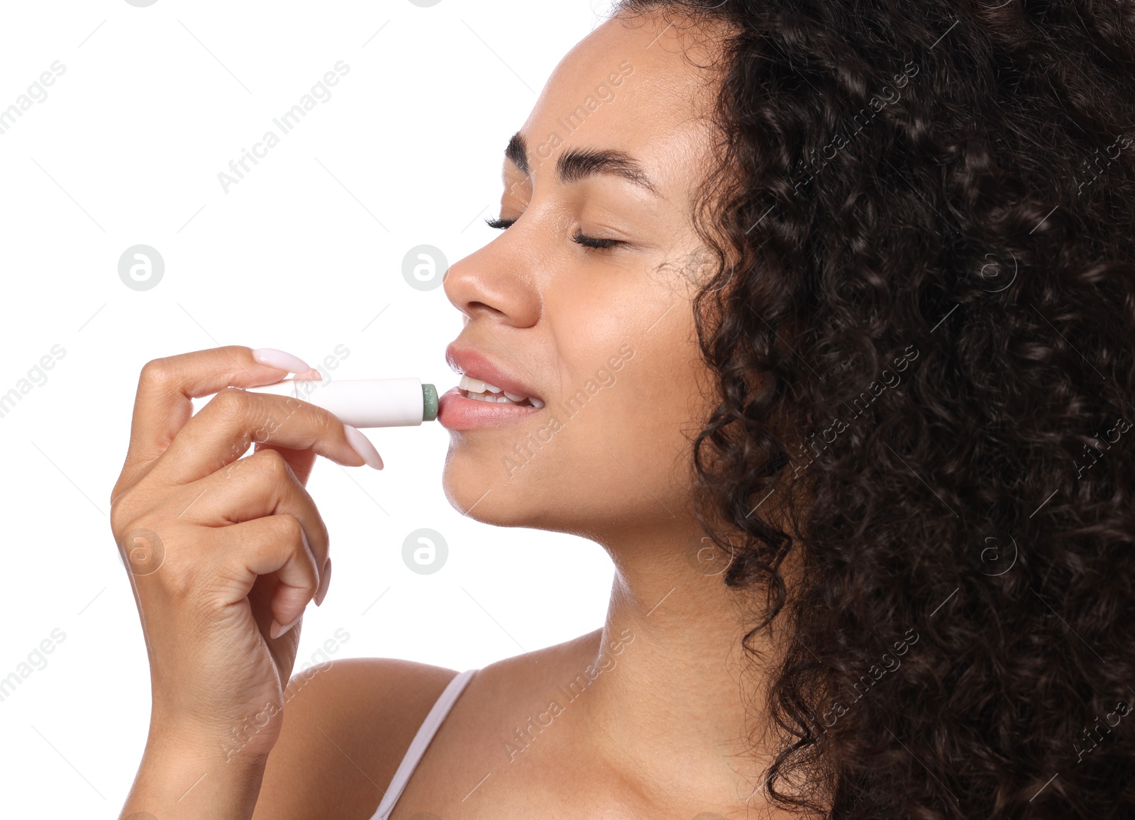 Smiling woman applying lip balm onto her lips on white background, closeup Photo of Smiling woman applying lip balm onto her lips on white background, closeup