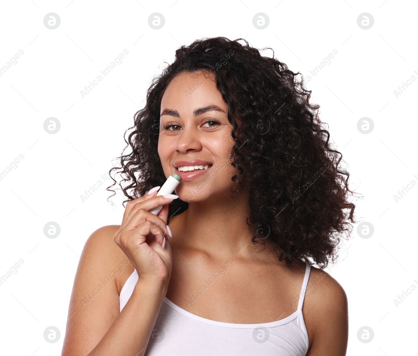 Smiling woman applying lip balm onto her lips on white background Photo of Smiling woman applying lip balm onto her lips on white background