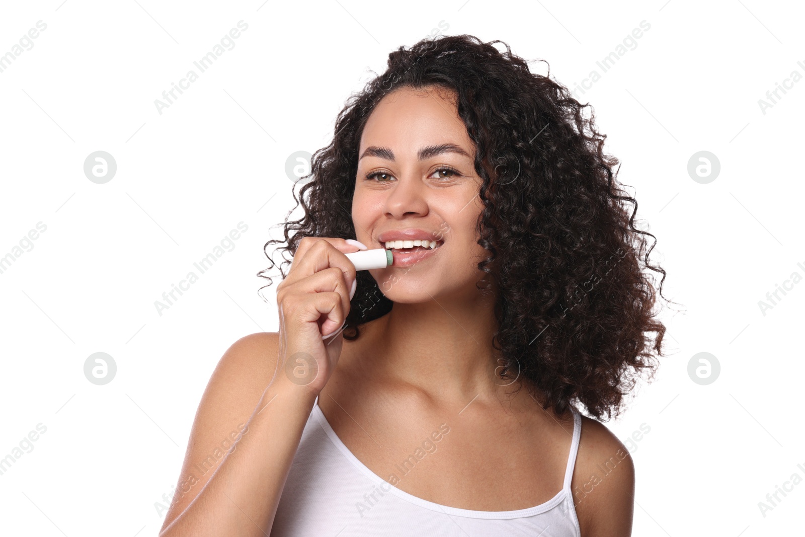 Smiling woman applying lip balm onto her lips on white background Photo of Smiling woman applying lip balm onto her lips on white background