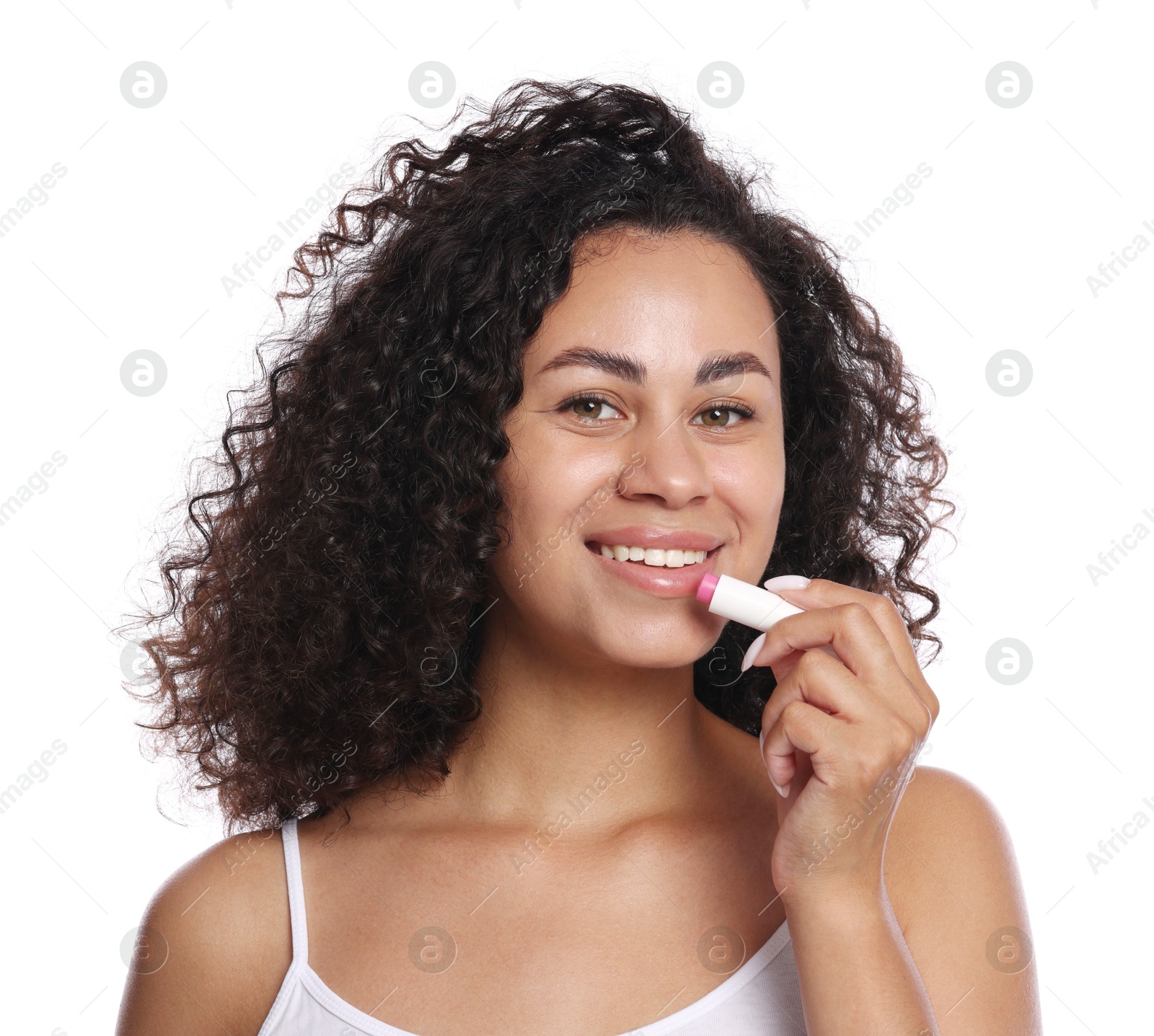 Smiling woman applying lip balm onto her lips on white background Photo of Smiling woman applying lip balm onto her lips on white background