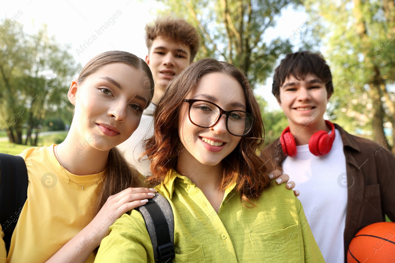 Group of teenagers taking selfie in park Photo of Group of teenagers taking selfie in park