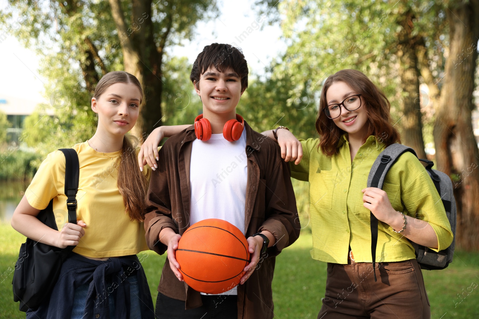 Three teenagers spending time together in park Photo of Three teenagers spending time together in park