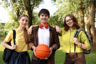 Photo of Three teenagers spending time together in park