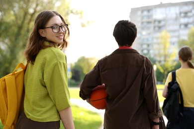 Photo of Three teenagers spending time together in park