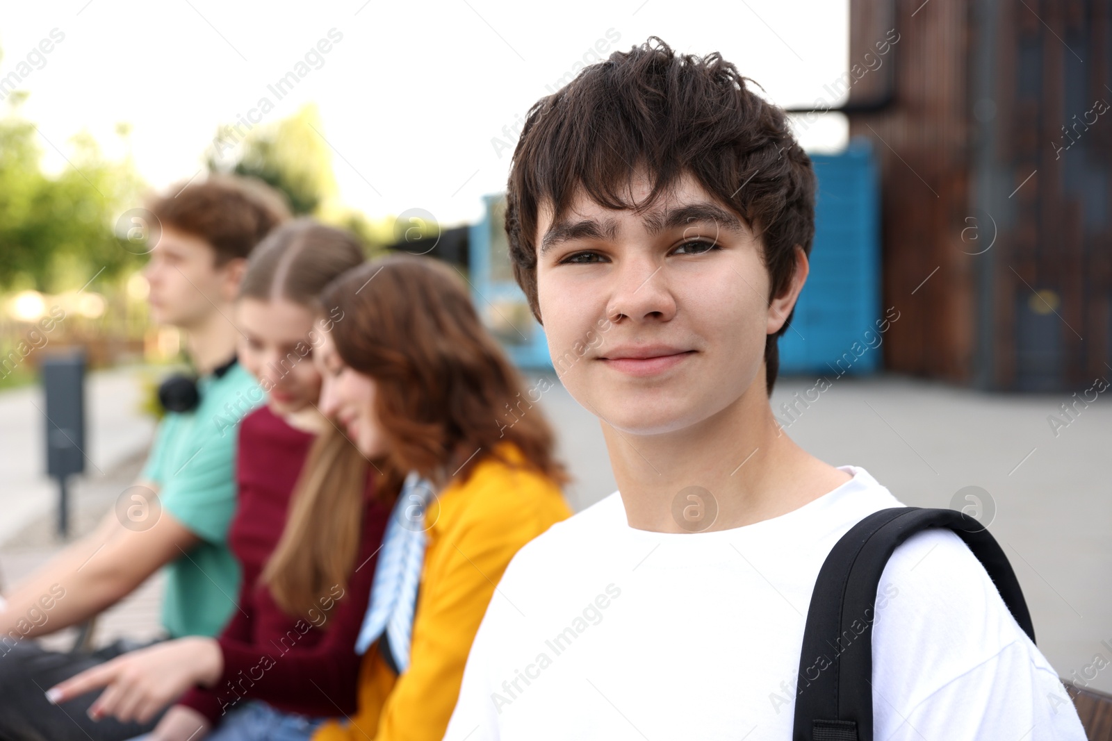 Teenagers spending time together outdoors, selective focus Photo of Teenagers spending time together outdoors, selective focus