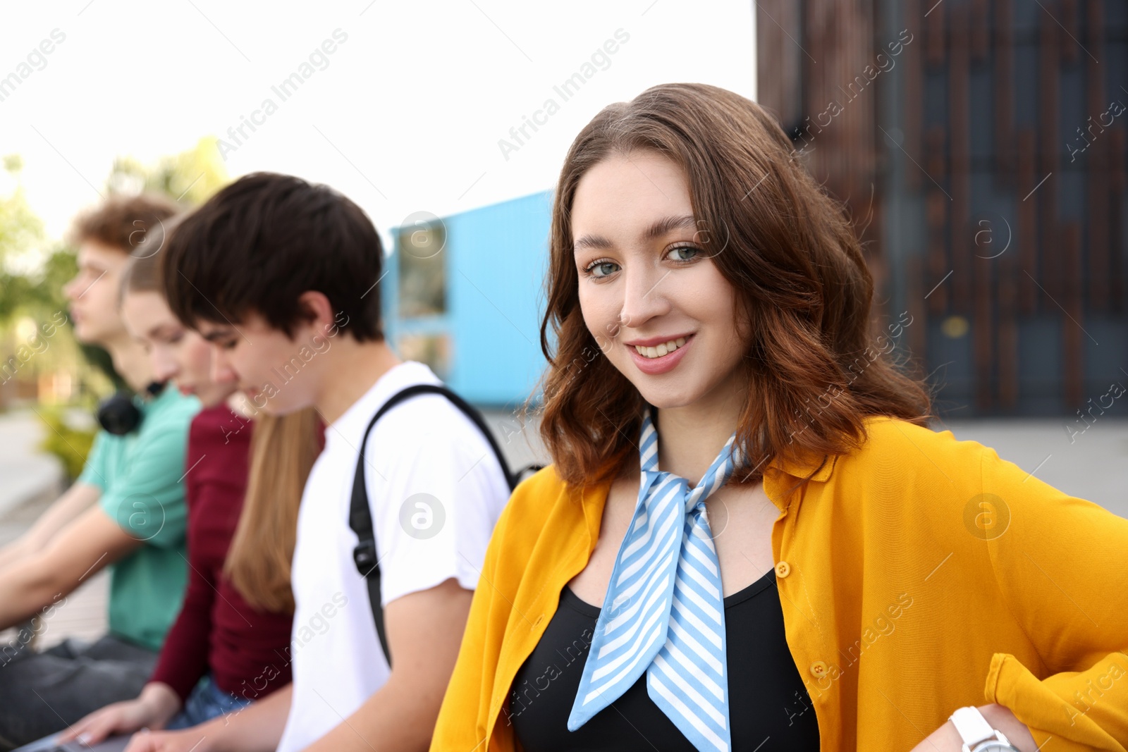 Teenagers spending time together outdoors, selective focus Photo of Teenagers spending time together outdoors, selective focus