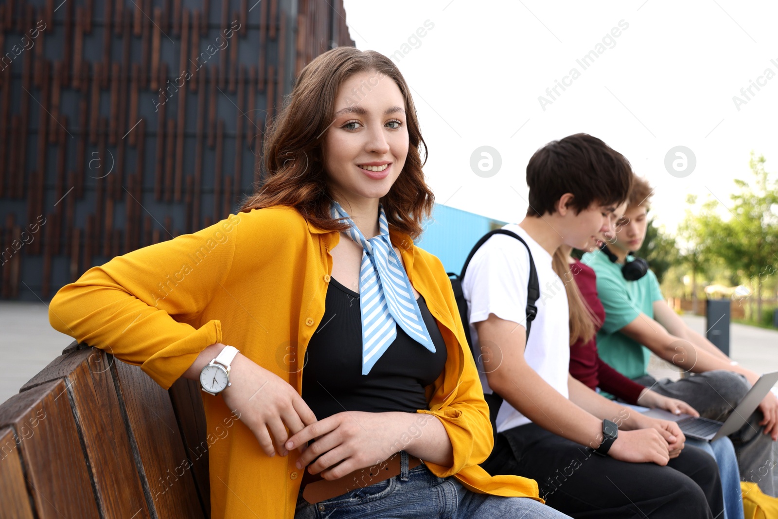 Teenagers spending time together outdoors, selective focus Photo of Teenagers spending time together outdoors, selective focus