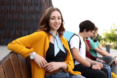 Photo of Teenagers spending time together outdoors, selective focus