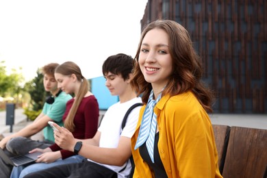 Photo of Teenagers spending time together outdoors, selective focus