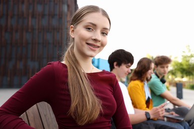 Photo of Teenagers spending time together outdoors, selective focus