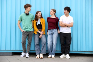 Photo of Group of teenagers posing near building outdoors