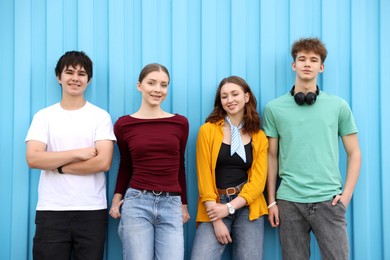 Photo of Group of teenagers posing near building outdoors