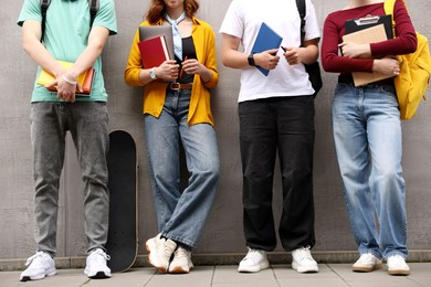 Photo of Group of teenagers posing near building outdoors, closeup