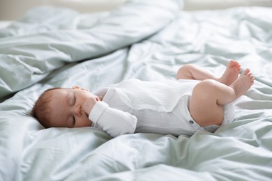 Photo of Cute sweet newborn baby sleeping on bed