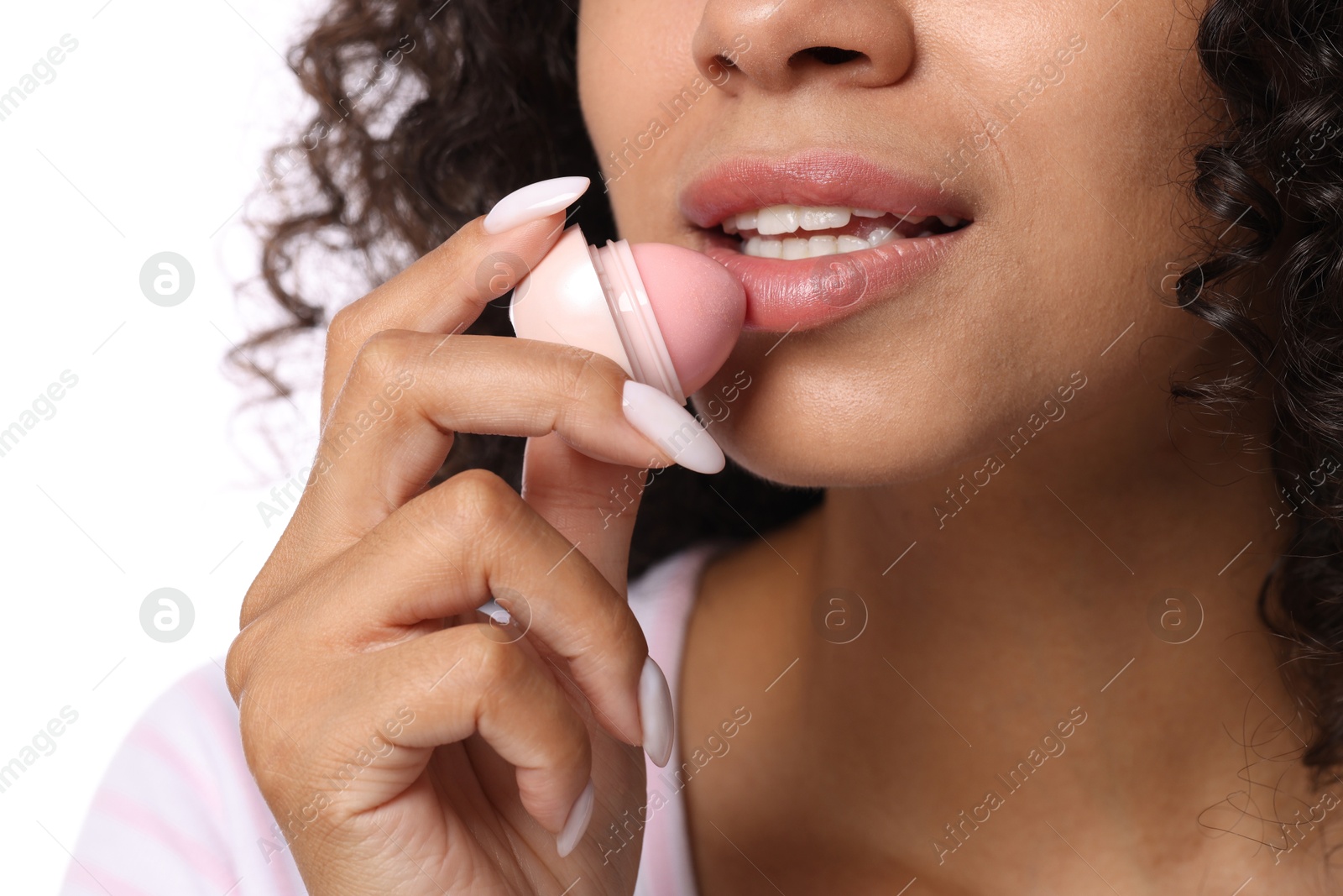 Woman applying lip balm onto her lips on white background, closeup Photo of Woman applying lip balm onto her lips on white background, closeup