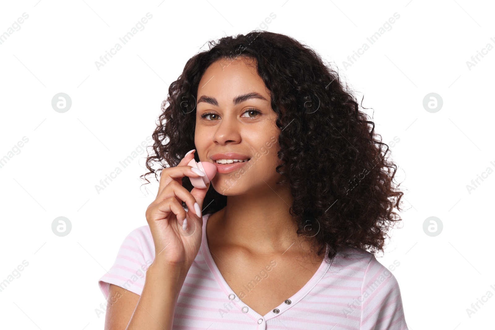 Smiling woman applying lip balm onto her lips on white background Photo of Smiling woman applying lip balm onto her lips on white background