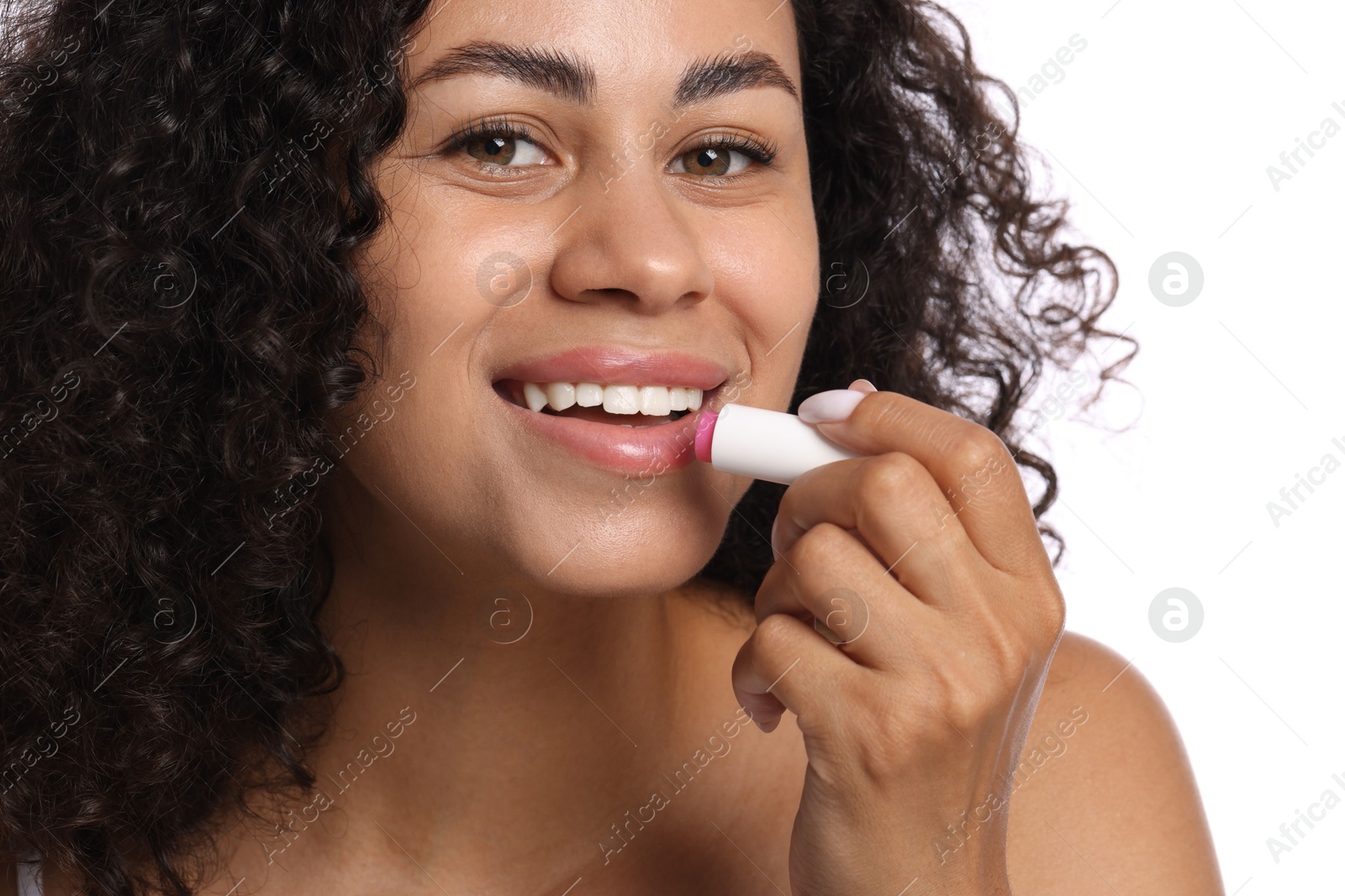 Smiling woman applying lip balm onto her lips on white background, closeup Photo of Smiling woman applying lip balm onto her lips on white background, closeup