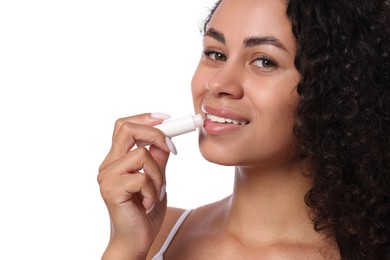 Photo of Smiling woman applying lip balm onto her lips on white background, closeup
