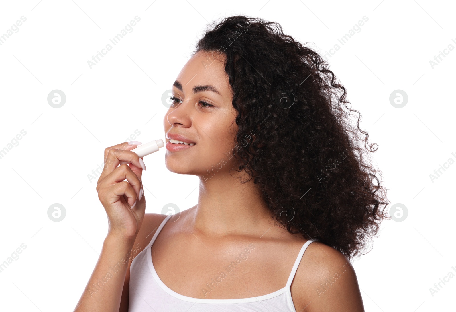 Smiling woman applying lip balm onto her lips on white background Photo of Smiling woman applying lip balm onto her lips on white background