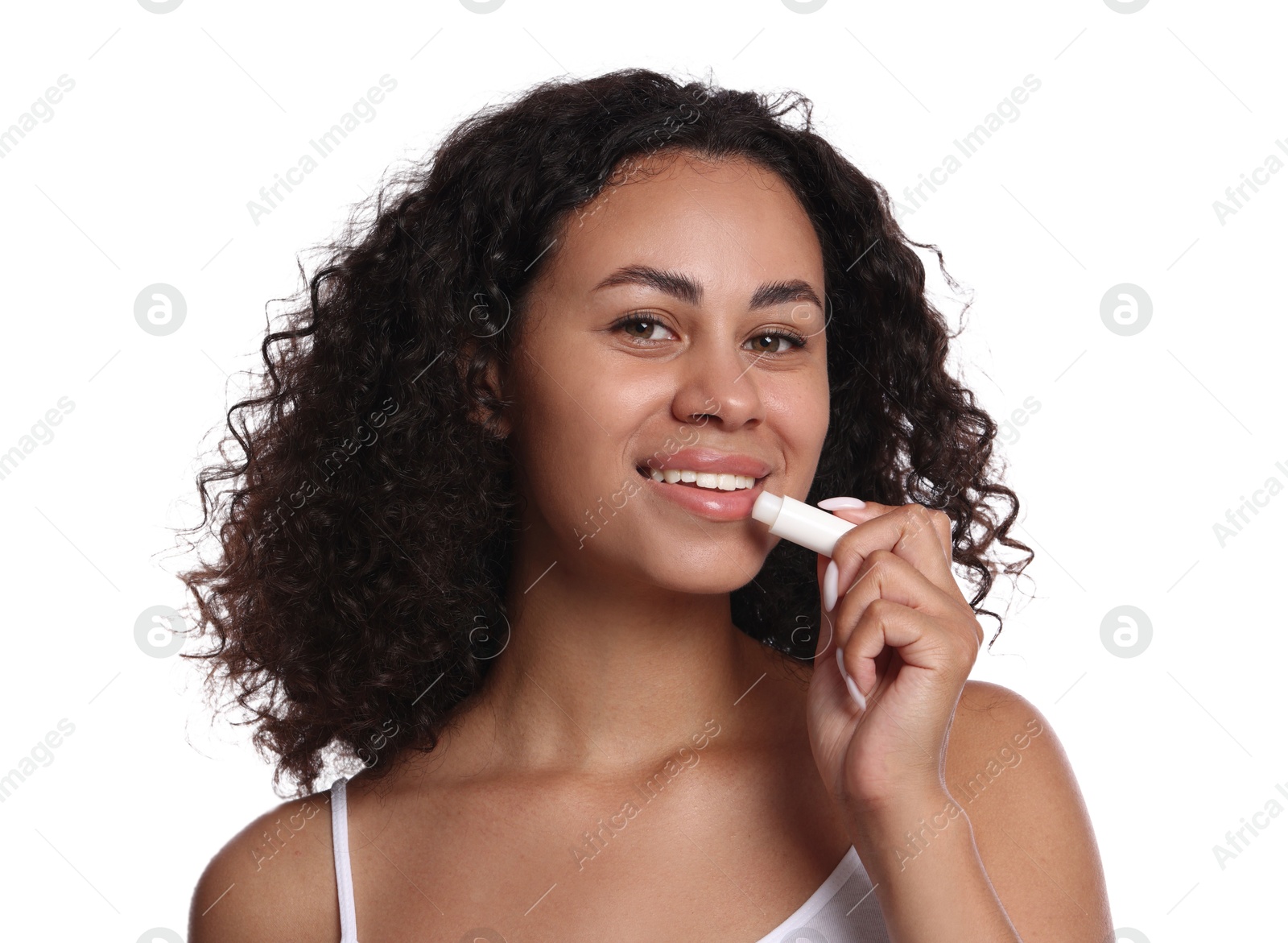 Smiling woman applying lip balm onto her lips on white background Photo of Smiling woman applying lip balm onto her lips on white background