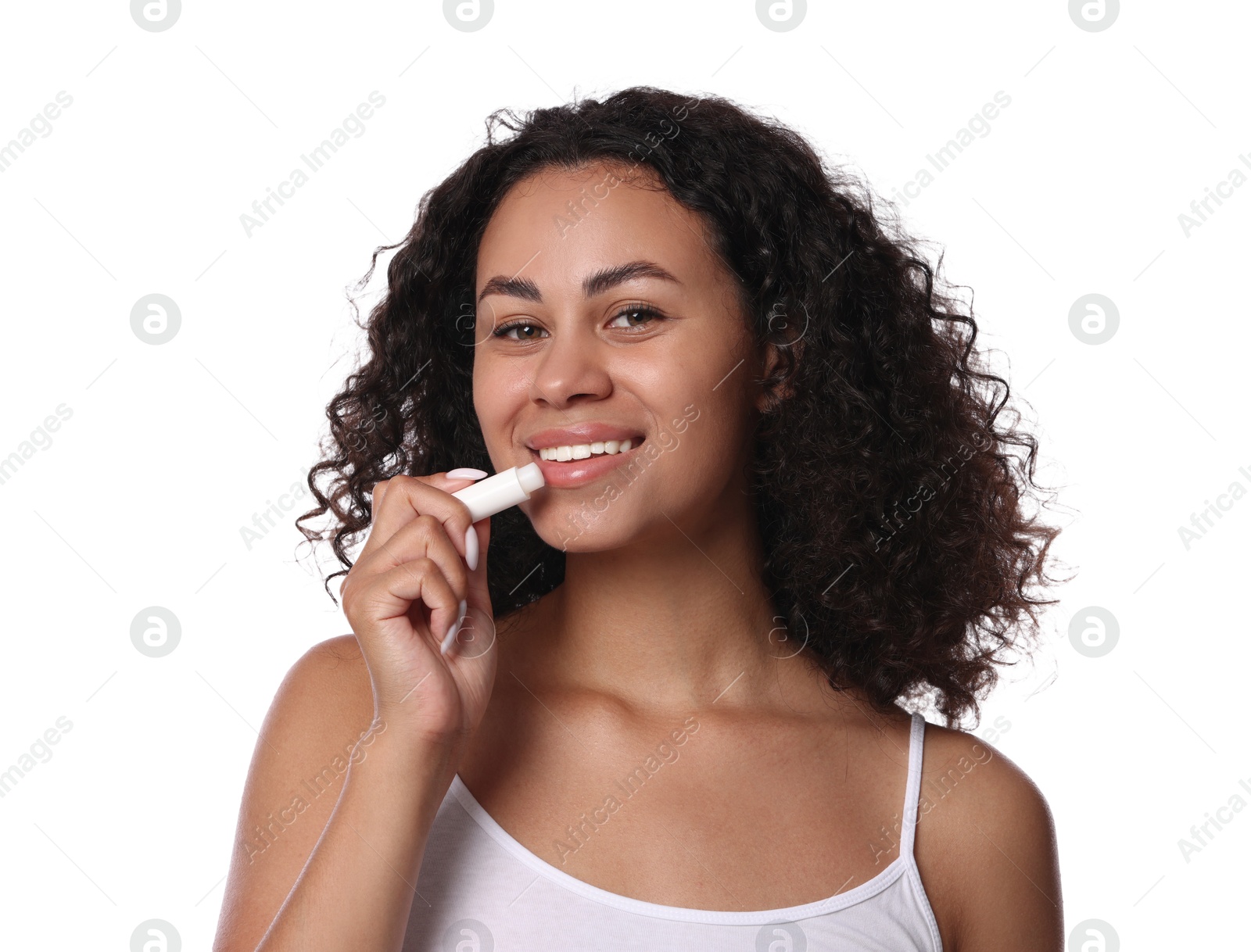 Smiling woman applying lip balm onto her lips on white background Photo of Smiling woman applying lip balm onto her lips on white background