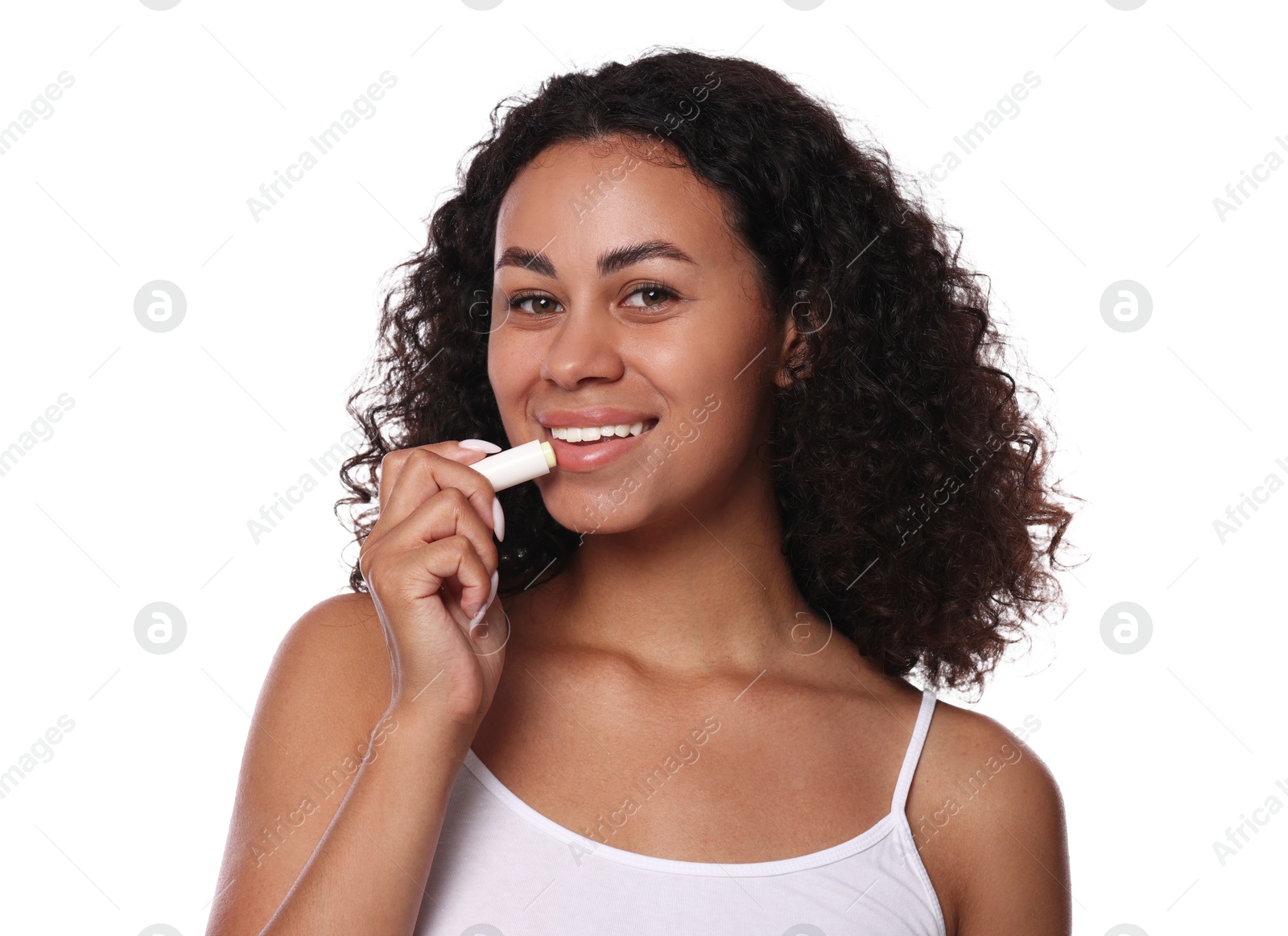 Smiling woman applying lip balm onto her lips on white background Photo of Smiling woman applying lip balm onto her lips on white background