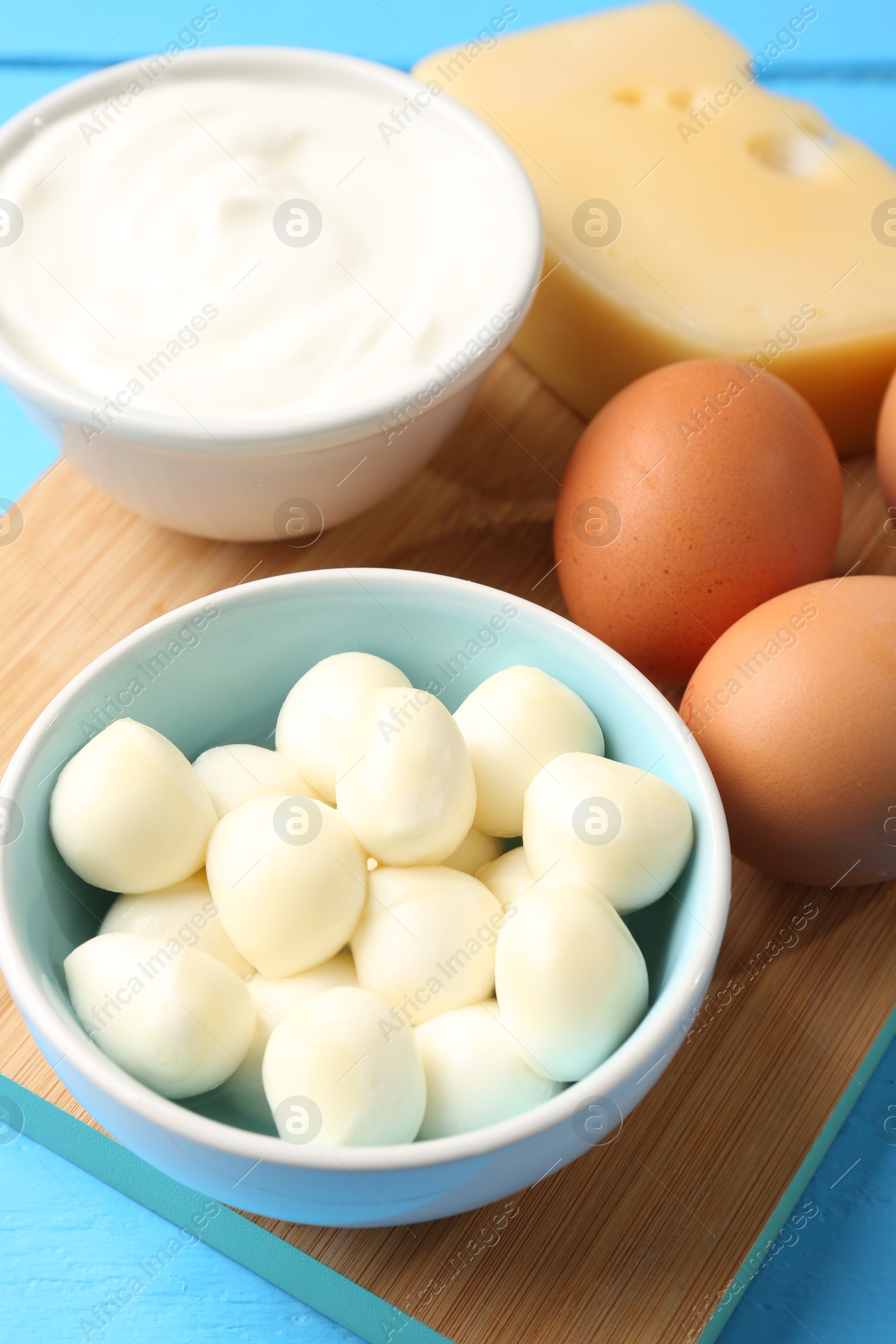 Different dairy products and eggs on light blue table, above view Photo of Different dairy products and eggs on light blue table, above view