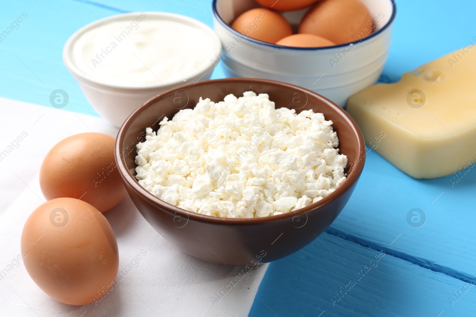 Different dairy products and eggs on light blue wooden table, closeup Photo of Different dairy products and eggs on light blue wooden table, closeup