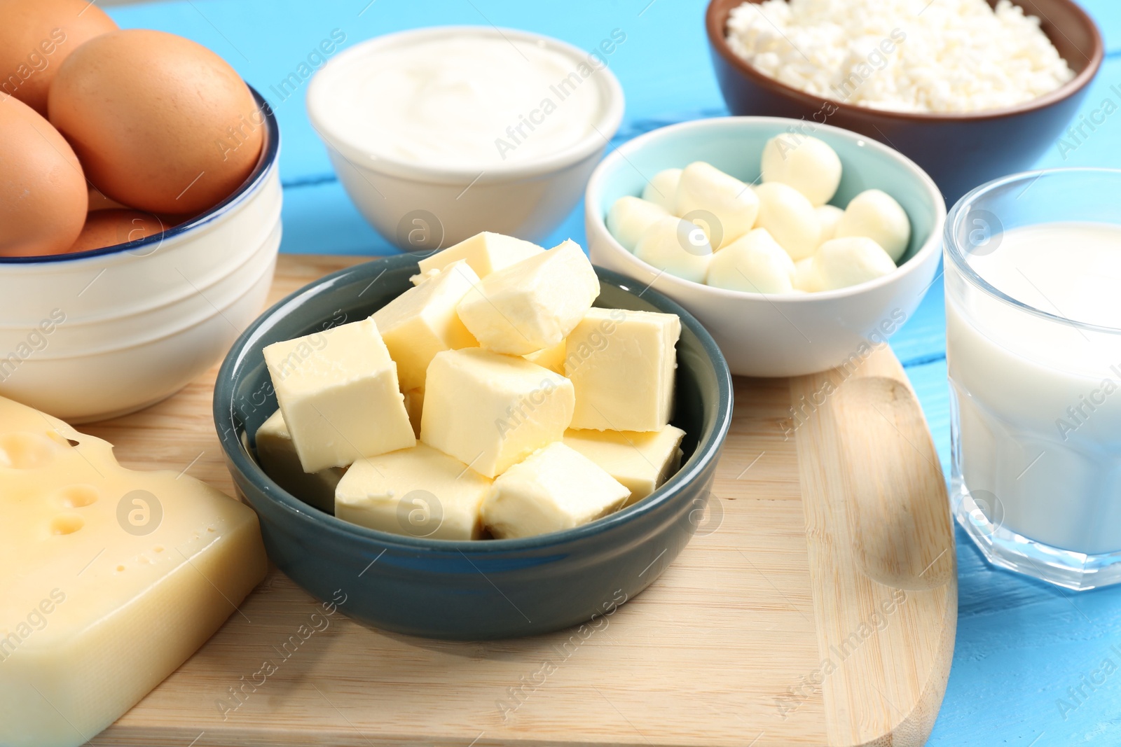 Different dairy products and eggs on light blue wooden table, closeup Photo of Different dairy products and eggs on light blue wooden table, closeup