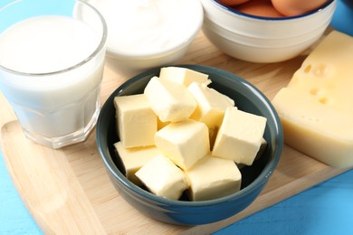 Photo of Different dairy products on light blue wooden table, above view