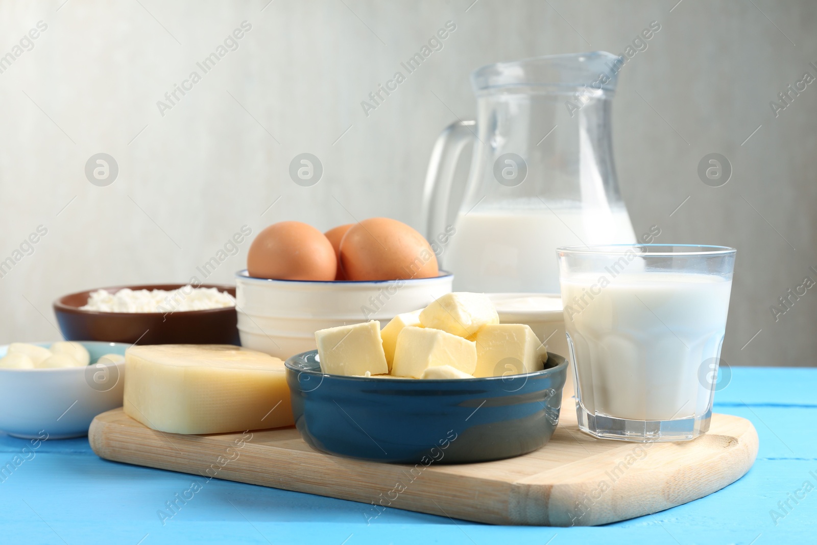 Different dairy products and eggs on light blue wooden table, closeup Photo of Different dairy products and eggs on light blue wooden table, closeup