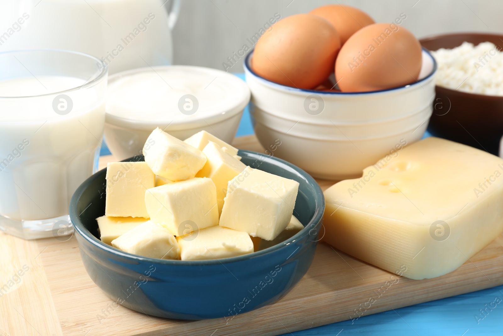 Different dairy products and eggs on light blue table, closeup Photo of Different dairy products and eggs on light blue table, closeup