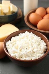 Photo of Different dairy products and eggs on grey wooden table, closeup