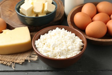 Photo of Different dairy products and eggs on grey wooden table, closeup