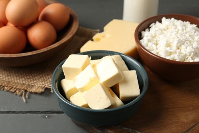 Photo of Different dairy products and eggs on grey wooden table, closeup