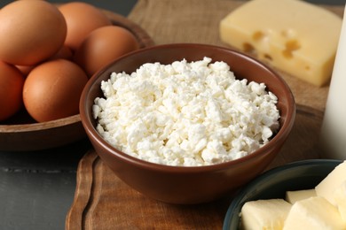 Photo of Different dairy products and eggs on grey wooden table, closeup