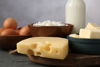 Photo of Different dairy products and eggs on grey wooden table, closeup