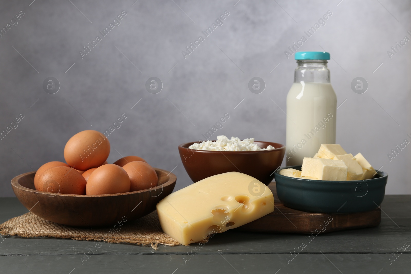 Different dairy products and eggs on grey wooden table Photo of Different dairy products and eggs on grey wooden table