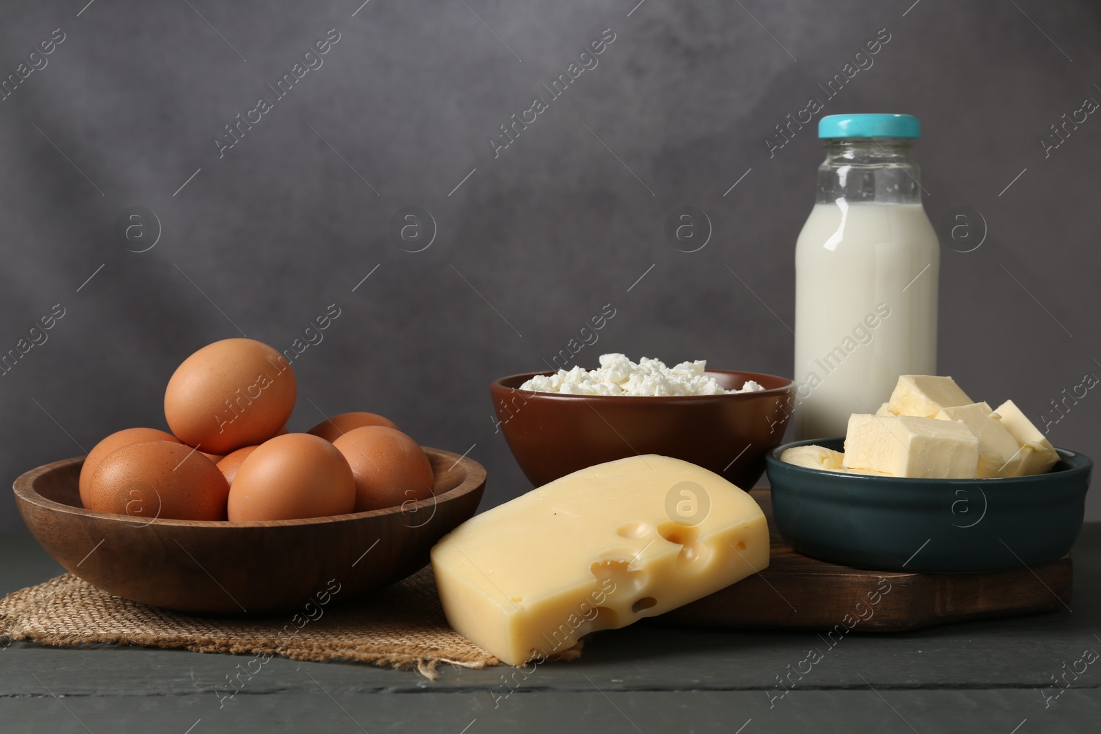 Different dairy products and eggs on grey wooden table Photo of Different dairy products and eggs on grey wooden table