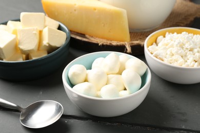 Photo of Different dairy products on grey wooden table, closeup