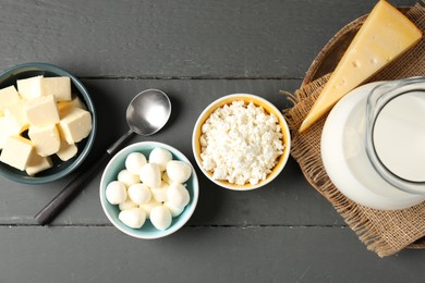 Photo of Different dairy products on grey wooden table, flat lay