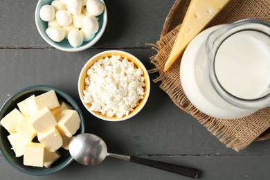 Photo of Different dairy products on grey wooden table, flat lay