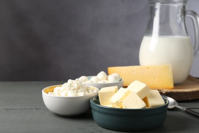 Photo of Different dairy products on grey wooden table, closeup