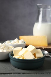 Photo of Different dairy products on grey wooden table, closeup