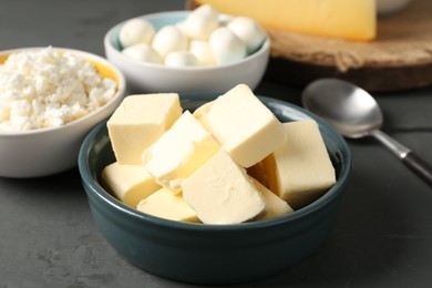 Photo of Different dairy products on grey wooden table, closeup