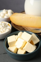 Photo of Different dairy products on grey wooden table, closeup