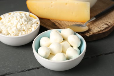 Photo of Different dairy products on grey wooden table, closeup