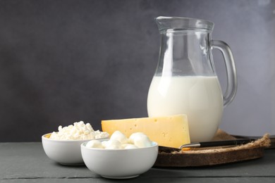 Photo of Different dairy products on grey wooden table