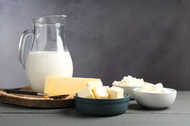 Photo of Different dairy products on grey wooden table
